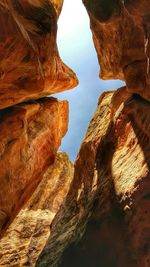 Low angle view of rocks with sky in background