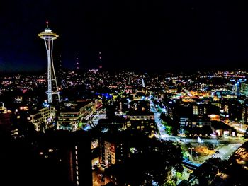 High angle view of city lit up at night