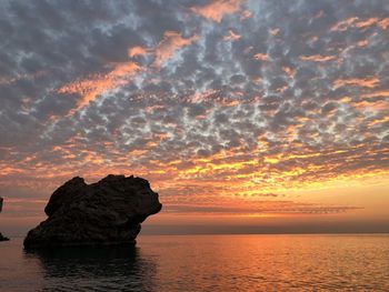 Scenic view of sea against romantic sky at sunset