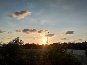 Scenic view of field against sky during sunset
