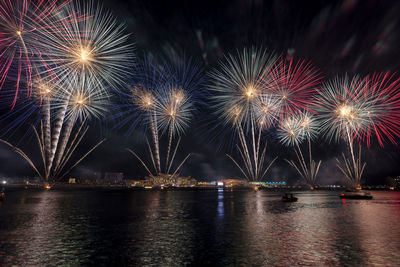 Low angle view of firework display at night