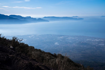 Scenic view of sea and mountains against sky