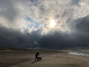 People on beach against sky