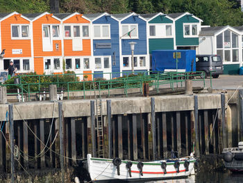 Boats in canal by buildings in city