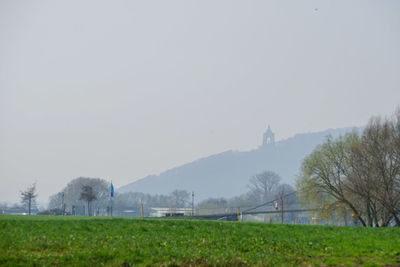 Scenic view of field against sky during foggy weather