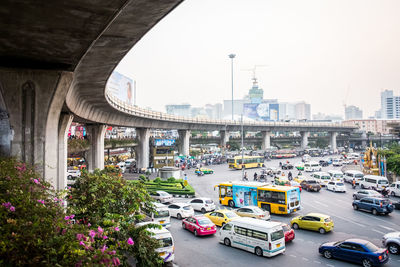 Traffic on road in city against sky