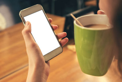 Midsection of man using mobile phone