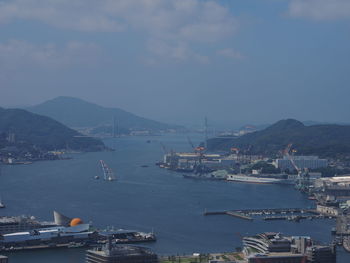 High angle view of harbor by city against sky