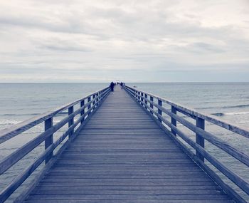 Pier over sea against sky