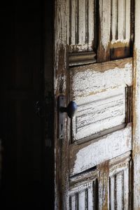 Historic cabin door with cracking white paint