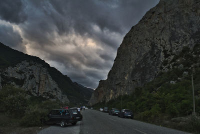 Cars on road against mountain range