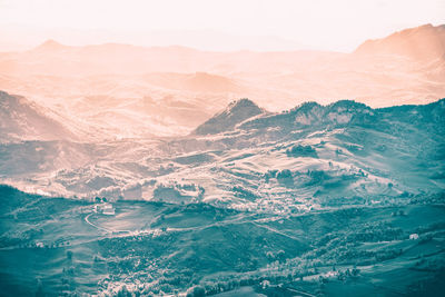 Aerial view of sea and mountains against sky