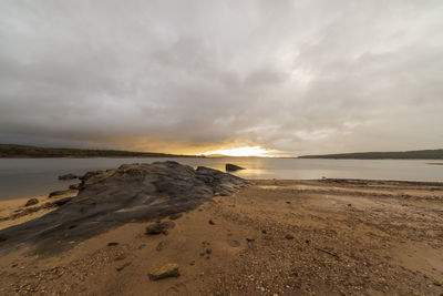 Scenic view of beach against sky during sunset