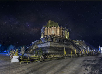 Illuminated building against sky at night