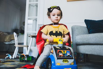 Boy sitting on sofa at home