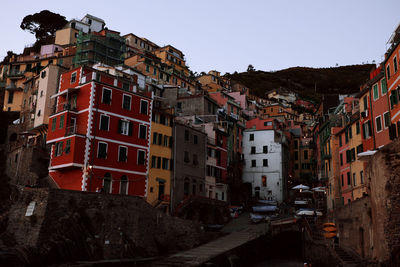 Buildings in city against clear sky