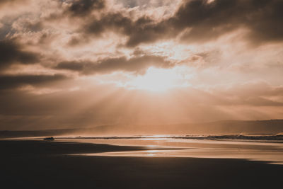 Scenic view of beach against sky during sunset