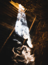 High angle view of burning candles on wood