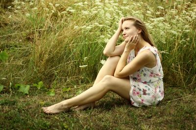 Young woman sitting on grass