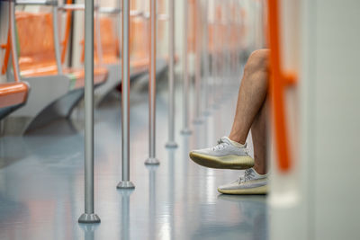 Low section of man sitting on chair