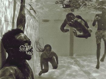 High angle view of people swimming in sea