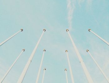 Low angle view of street light against blue sky