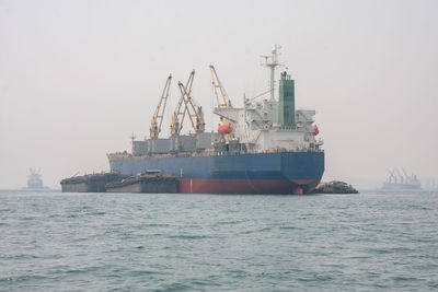 Ship in sea against sky