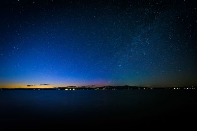 Scenic view of lake against star field at night