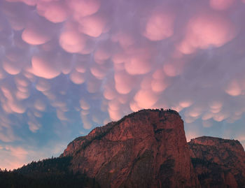 Pink sunset over the mountains with mammatus in the sky