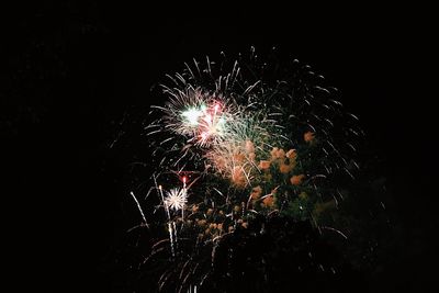 Low angle view of firework display at night