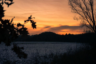 Scenic view of lake against orange sky