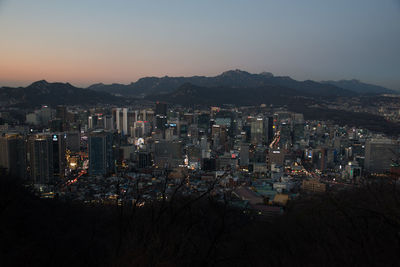 High angle view of illuminated buildings in city against sky