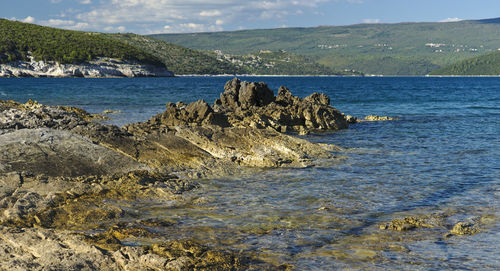 Scenic view of sea against cloudy sky