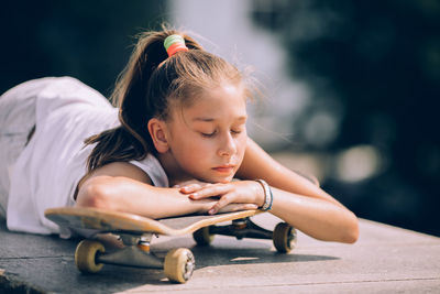 Cute girl sitting outdoors