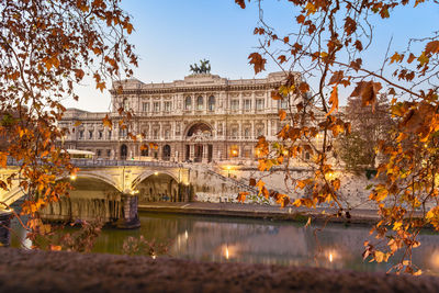 View of bridge over water in city of rome and justice palace