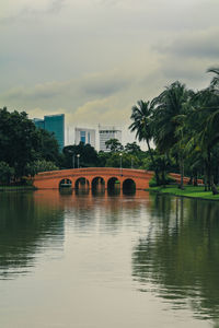 Arch bridge over river against sky