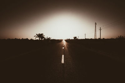 Road against clear sky at sunset