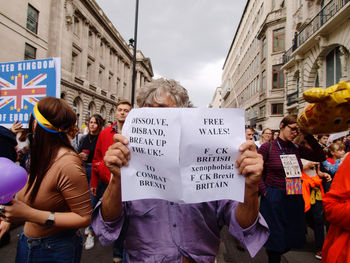 People protesting on street amidst buildings in city