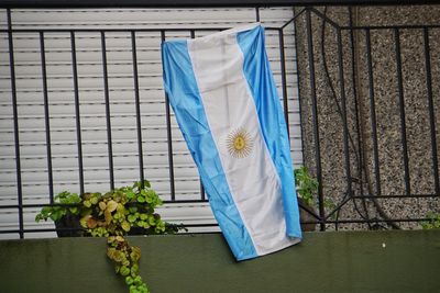 White clothes drying against blue window