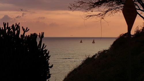 Scenic view of sea against sky at sunset