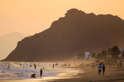 Bathers or vacationers on the beach at sunset in bahia 