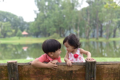 Rear view of mother and daughter in water