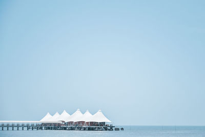 Scenic view of white building on the sea against clear sky