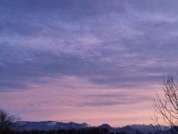 Scenic view of silhouette mountains against romantic sky at sunset