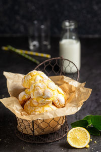 Homemade lemon crinkle cookies with powdered sugar icing on backing paper in small metal backed ,