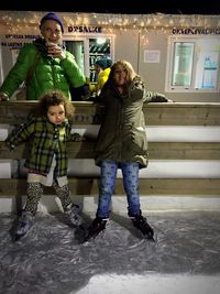 Full length portrait of happy siblings
