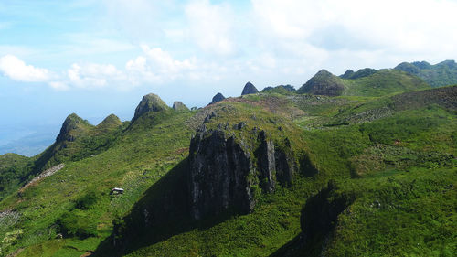 Panoramic view of green landscape against sky