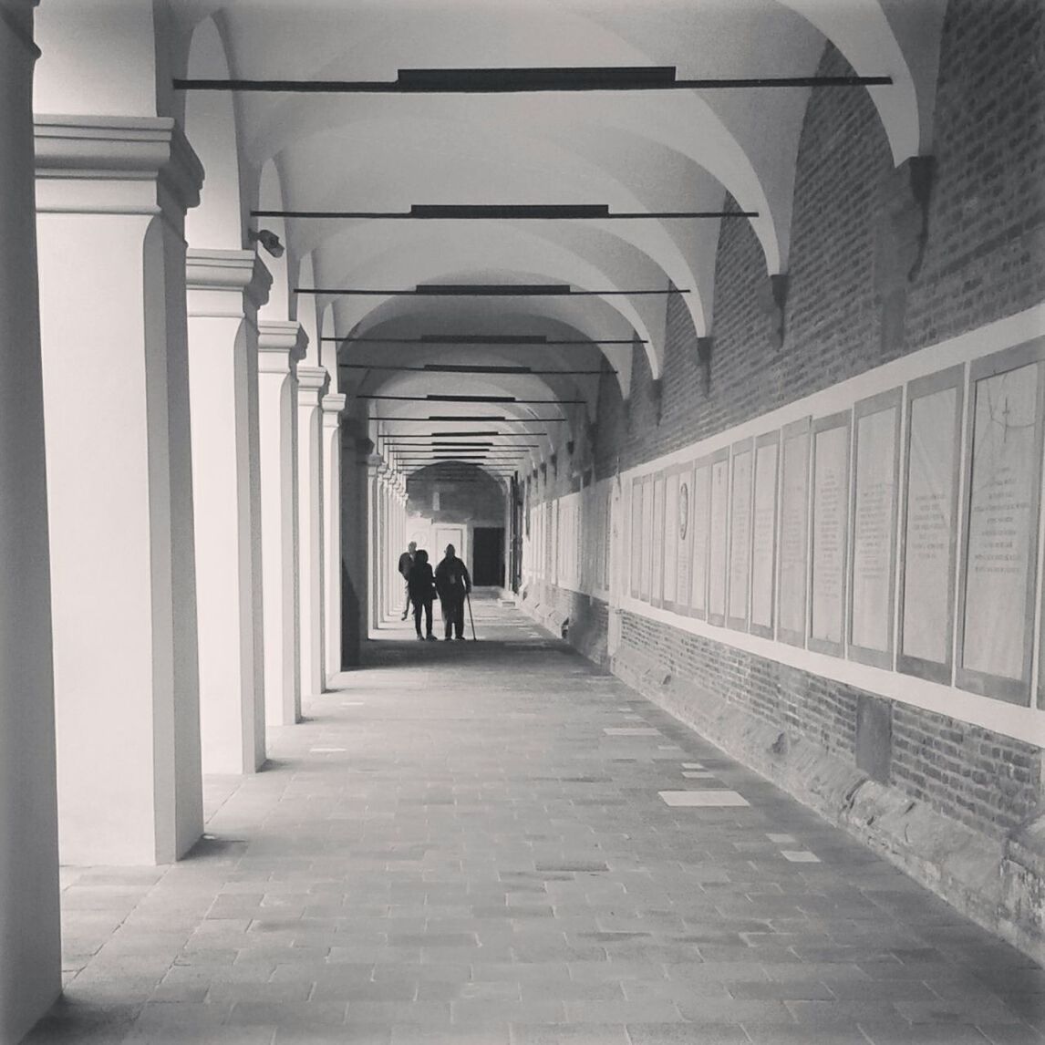 walking, the way forward, men, rear view, architecture, full length, indoors, built structure, lifestyles, person, corridor, leisure activity, arch, diminishing perspective, walkway, colonnade, vanishing point