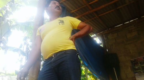 Low angle view of young woman looking at camera