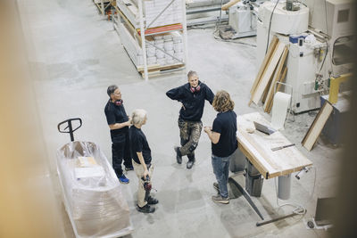 High angle view of workers discussing in meeting at industry